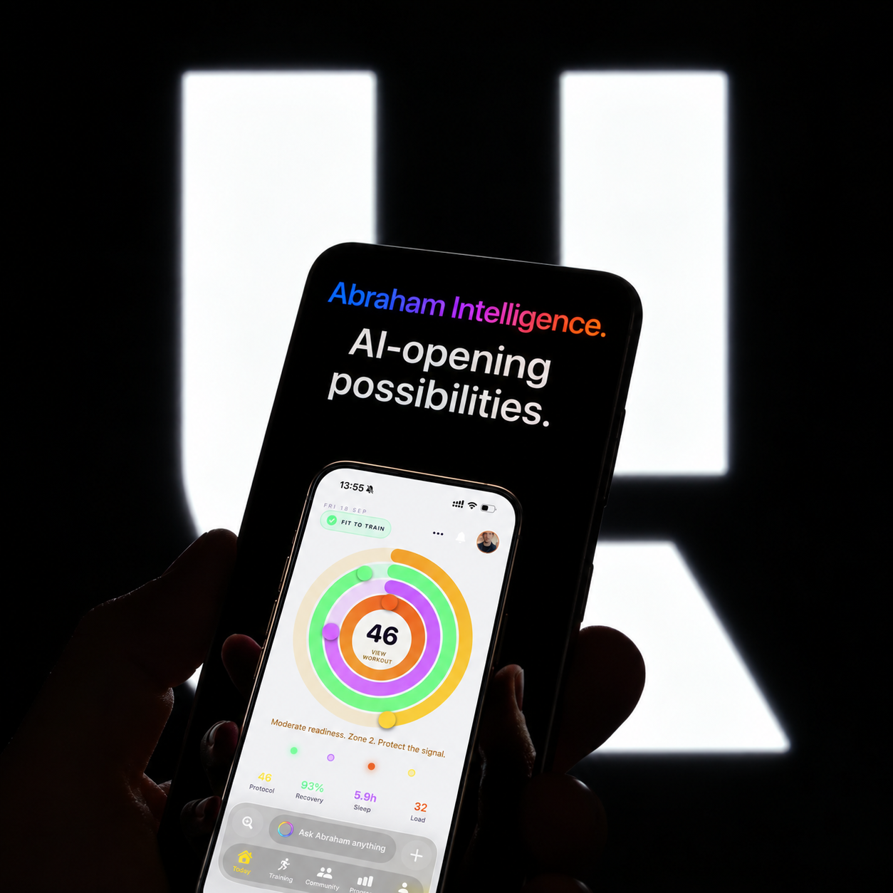 Abraham Intelligence. AI-opening possibilities. A handheld Unbroken app against an illuminated Unbroken mark