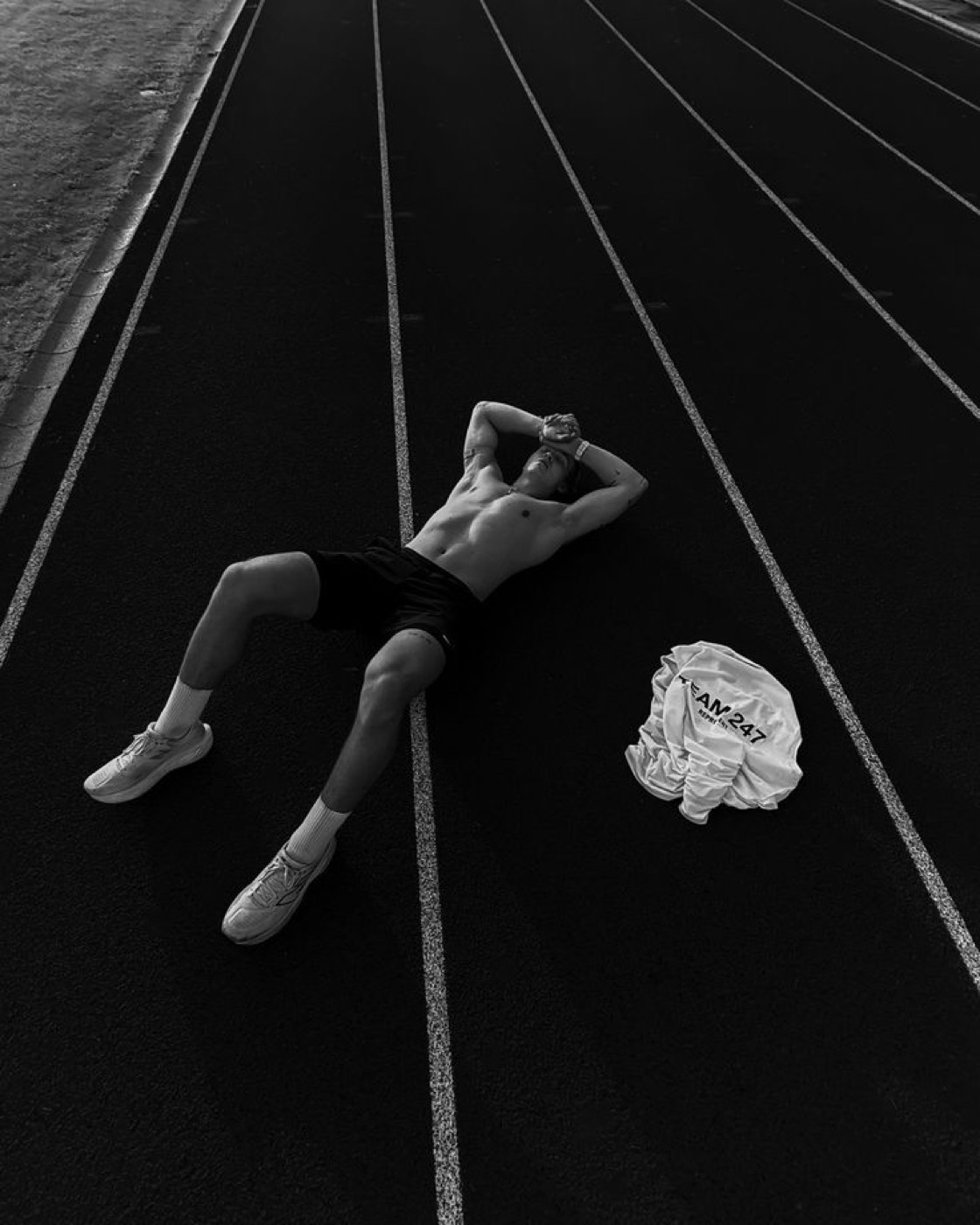 An athlete lying on the track after finishing